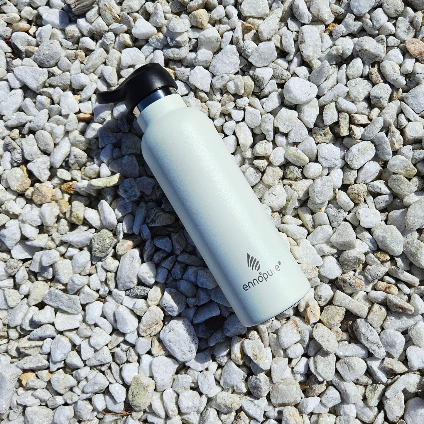 ePureFlo white water bottle on pebbles