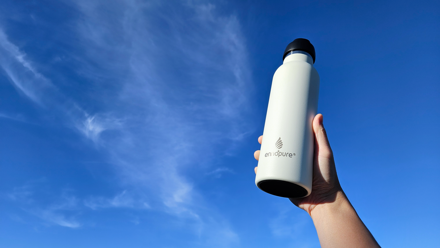 ePureFlo white water bottle held up to the sky
